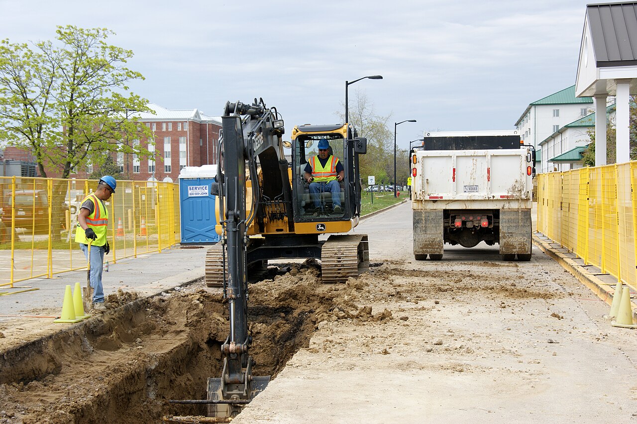 Workers excavate a trench for a water main replacement project at Naval Station Great Lakes, Illinois