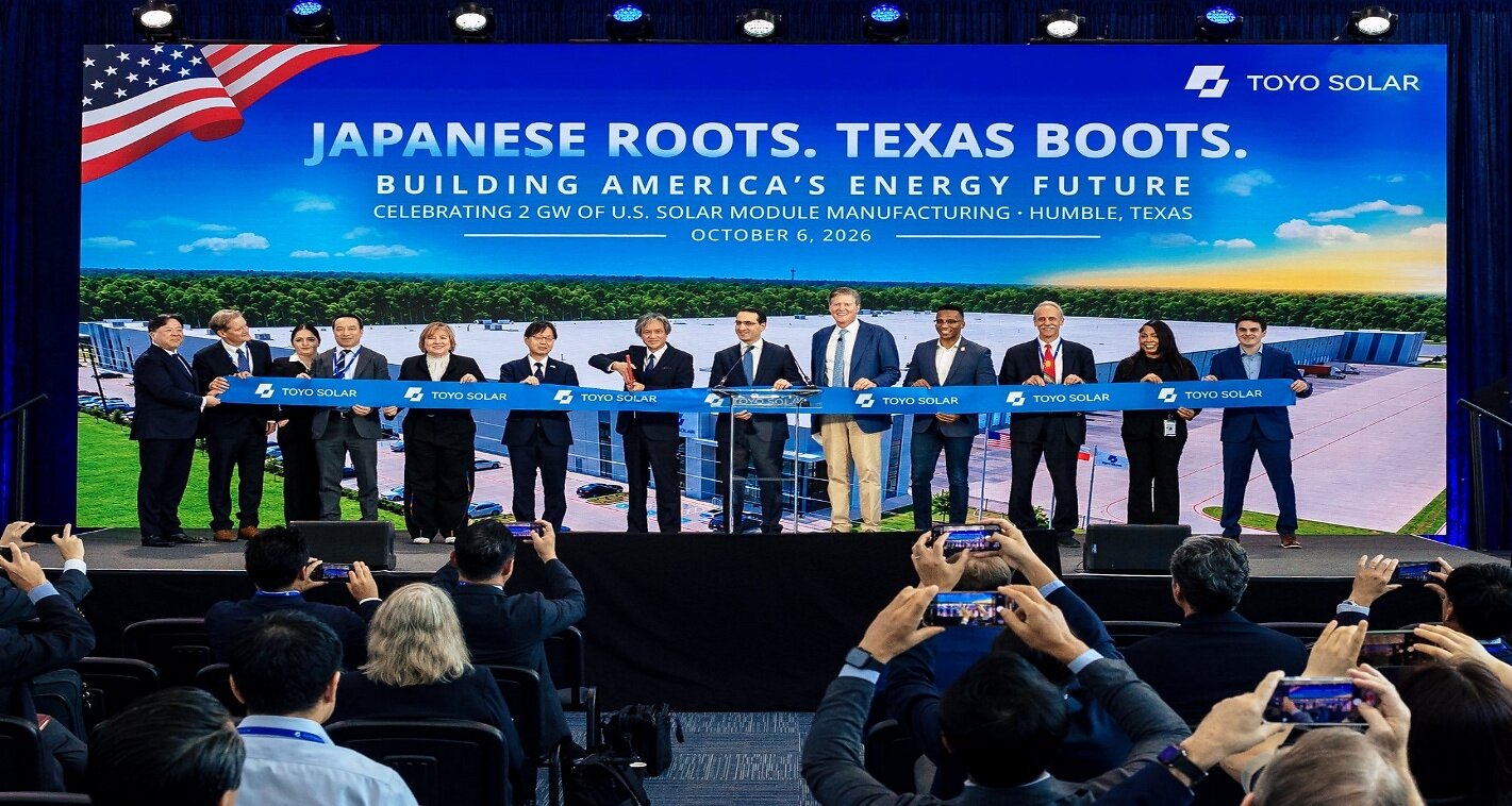 Officials cut a blue TOYO Solar ribbon on stage at the company's module factory ribbon-cutting in Humble, Texas